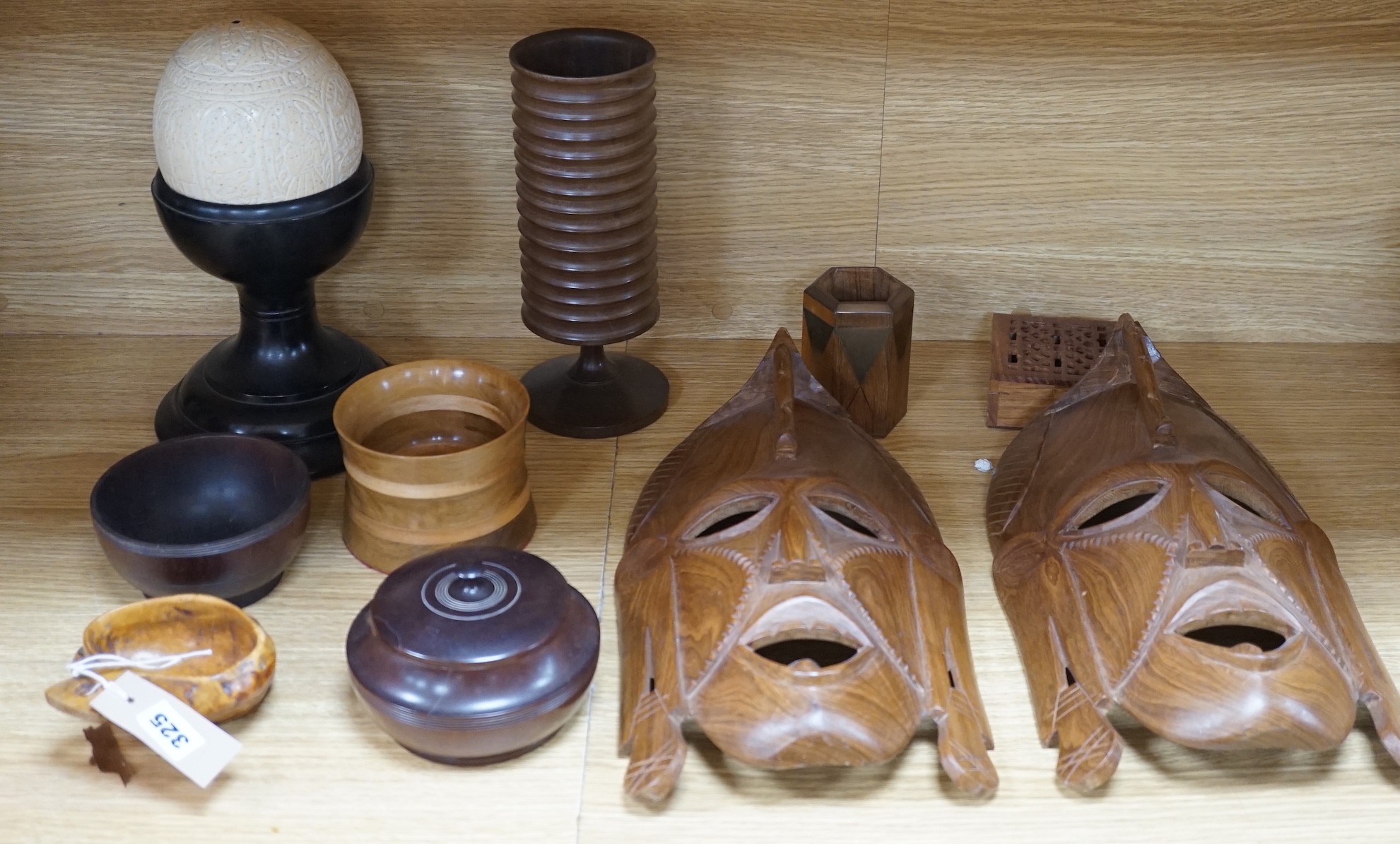 A quantity of African and other carvings including an ostrich egg